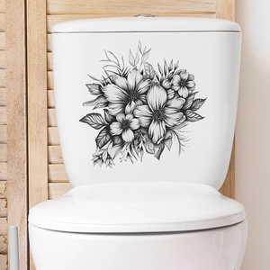 Detail of artistic black and white floral wall stickers on a white ceramic toilet tank