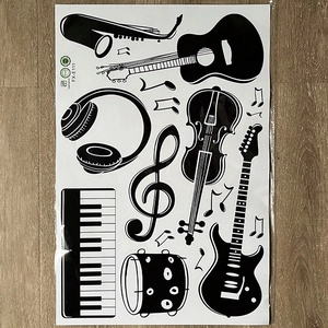 Flat lay macro of music instrument silhouettes and notes stickers on wooden background