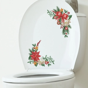 Christmas bow and poinsettia decals on white toilet lid for holiday home decoration