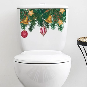 Christmas tree bell stickers on white toilet tank with festive holiday decorations