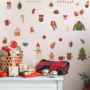 Christmas wall decal set with snowman and tree motifs on a warm pink wall backdrop