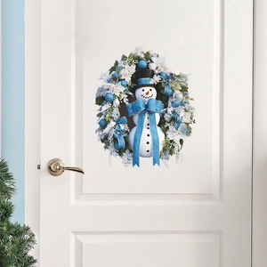 Christmas snowman wreath with blue and white decorations on a white door
