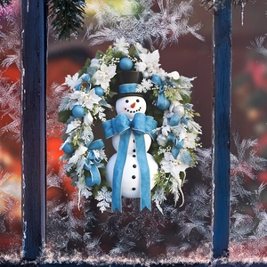 Christmas snowman wreath with blue bow and white flowers on frosted glass window