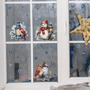Christmas window stickers featuring watercolor snowman, birds, and blue snowflakes on glass