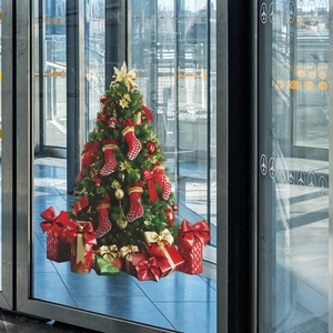Detail of Christmas tree wall sticker with gift boxes and ornaments on glass