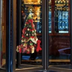 Detail showing a decorated Christmas tree wall sticker with gifts and a red stocking