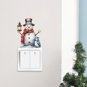 Watercolor snowman wall sticker with a blue bird and lantern above a light switch cover