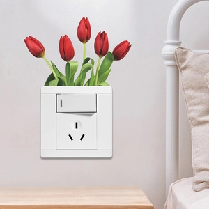 Wall switch panel decorated with red tulip decals in a warm bedroom setting