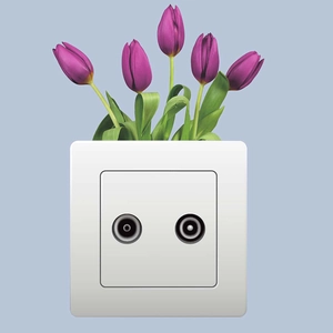 Close-up of dual-port white TV signal wall socket decorated with purple tulips floral art