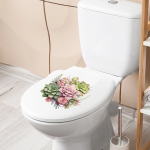 Detail of floral wall sticker with pink roses and succulents on a white toilet lid