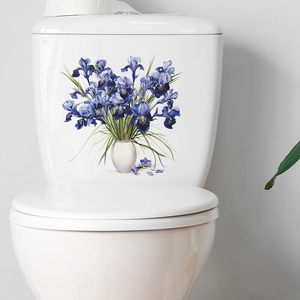 Floral iris wall sticker decorates a white ceramic toilet tank in a modern bathroom
