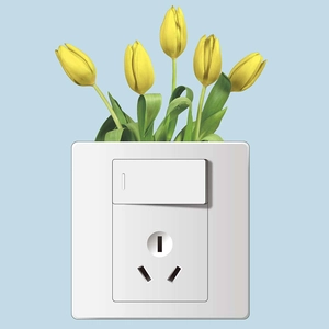 Detail of white light switch and power outlet decorated with yellow tulip wall stickers