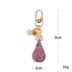 Handmade Chinese style pipa bag charm in purple silk with golden metal details, 9cm height