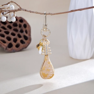 Chinese retro pipa keychain charm with yellow floral fabric and elegant crystal accents