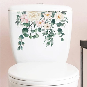 Detailed view of vintage floral toilet stickers with pink cherry blossoms and green leaves