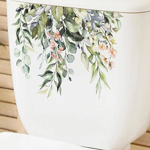 Close-up of tropical green leaves and pink flowers wall sticker on a white ceramic surface