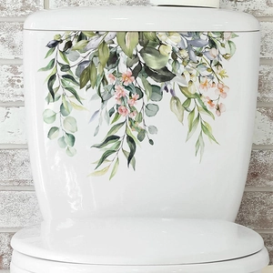 Tropical green leaves and pink flowers wall sticker on a white bathroom toilet tank