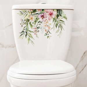 Detail of floral watercolor wall stickers with tropical leaves on a ceramic toilet tank