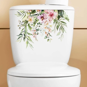 Detail showing tropical floral hibiscus and green leaf stickers on a white toilet tank