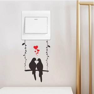 Self-adhesive decorative wall sticker featuring black birds on a swing with red hearts