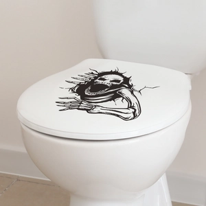 Close-up of a 3D cracked skull wall decal applied to a white toilet lid in a bathroom