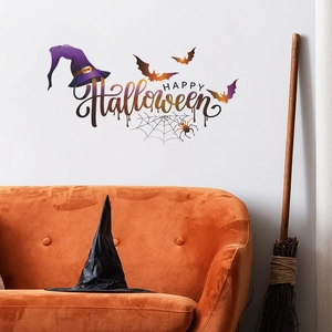 Macro detail of Happy Halloween wall sticker with purple witch hat and black bats on white wall