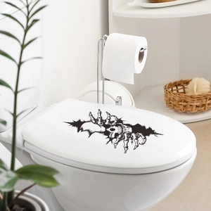 Adesivi neri a mano di scheletro con effetto crepa su un moderno sedile del water bianco
