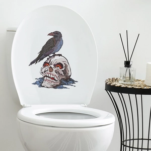 Halloween toilet sticker showing a black crow on a skull with red glowing eyes in a bathroom