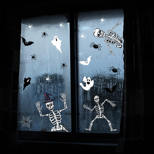 Macro detail of white Halloween window stickers with spooky skeletons, bats and spider webs