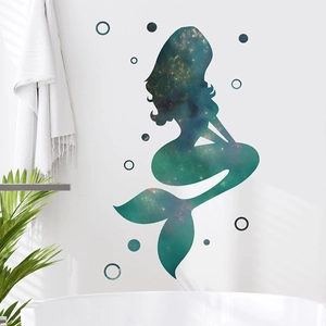 Starry galaxy mermaid wall sticker for bathroom decor on white wall with green plants