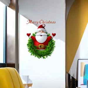 Close-up of Merry Christmas wall decal with Santa Claus and wreath on a white wall