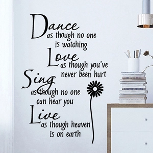 Detailed view of black inspirational quotes wall sticker with floral design in a cozy room