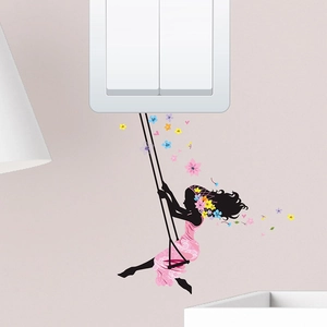 Detail of creative flower fairy wall sticker with a girl on a swing for light switch decor