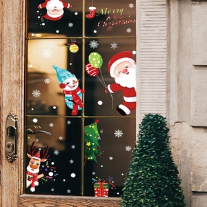 Detail view of cartoon Santa and snowman static stickers on a glass door