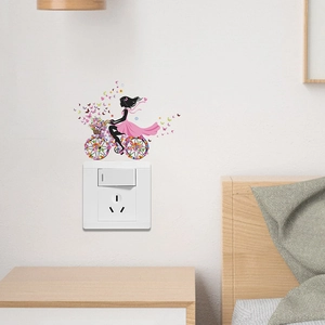 Floral fairy riding a flower bicycle wall sticker near an outlet for room decor