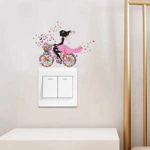 Artistic wall sticker featuring a girl on a bicycle with flowers and colorful butterflies