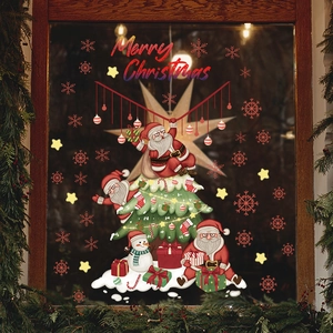 Detail of Christmas window stickers with Santa, tree, and snowman on glass window decor