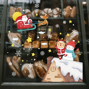 Christmas window decals with Santa Claus and reindeer on a bakery glass storefront
