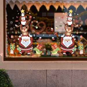 Christmas window stickers featuring cartoon Santa Reindeer and Snowman on a bakery glass pane