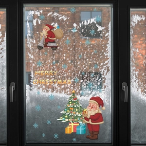 Detail of Christmas window stickers with Santa on motorcycle and snowflakes on glass