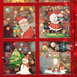 Detail of Christmas window stickers with Santa, snowman and bear on glass panel