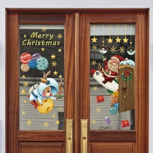 Detail of Santa and reindeer window stickers on a glass door for Christmas decor
