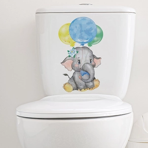 Watercolor cartoon elephant holding balloons wall decal applied on white toilet tank