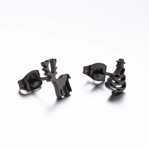 Close-up of black stainless steel Christmas reindeer and tree asymmetric stud earrings