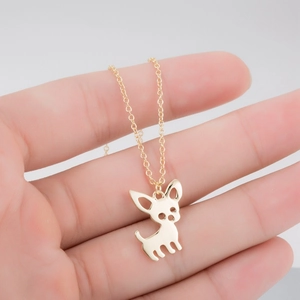 Close-up of a gold chihuahua silhouette pendant on a delicate stainless steel chain