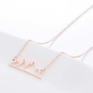 Minimalist rose gold stainless steel hollow mountain peak pendant on a fine cross chain