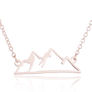 Detailed macro of rose gold mountain peak pendant with elegant hollow silhouette