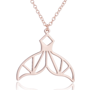 Detailed close-up of rose gold mermaid tail pendant necklace with a mirror reflection