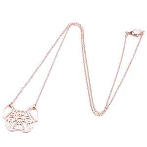 Close-up of rose gold pug pendant with geometric cutout and lobster clasp detail