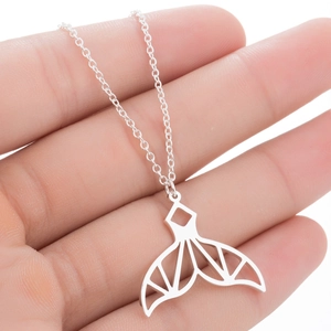 Minimalist silver mermaid tail necklace featuring a geometric cutout whale pendant design